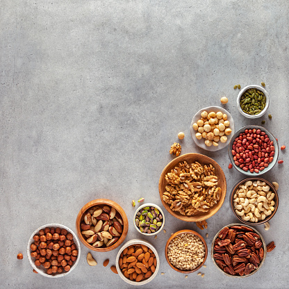 Close-up of various nuts and seeds in bowls. Copy space.