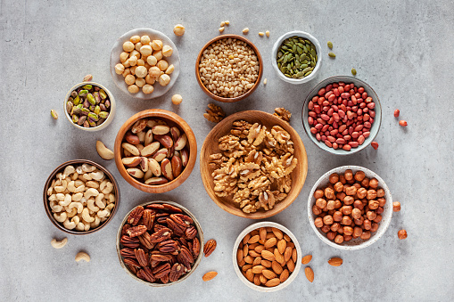 Close-up of various nuts and seeds in bowls.