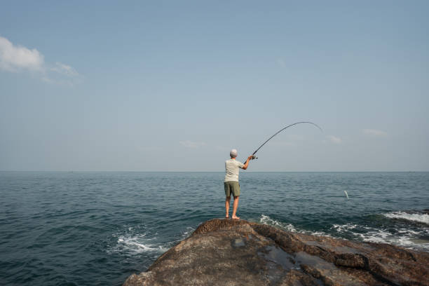 istock Senior man spin fishing 1471589536