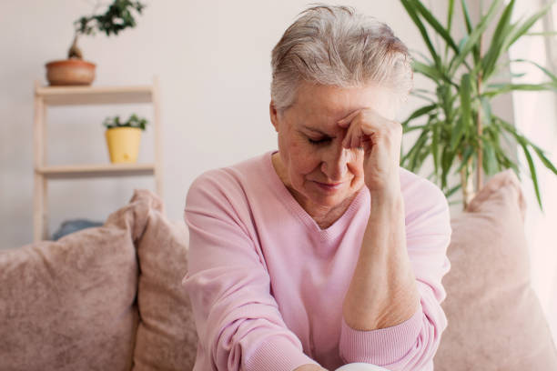 istock middle aged lady looking away sit alone at home feel anxious lonely, sad 1471590337