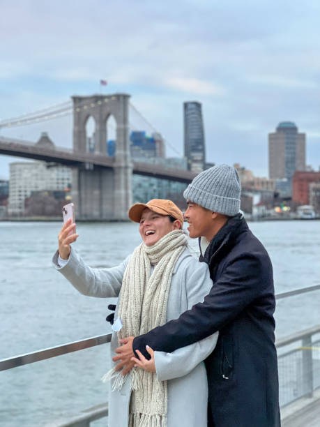 istock Couple taking selfie in NYC with the Brooklyn bridge 1471590992