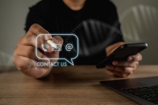 istock CONTACT US (Customer Support Hotline people CONNECT ) Businessman touching phone application check  email 1471594868