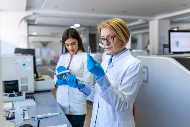 istock Modern Medical Research Laboratory: Female Scientist Working with Micro Pipette, Using Digital Tablet for Test Sample Analysis. Advanced Scientific Lab for Medicine, Biotechnology Development. 1471594930