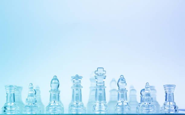 istock Glass chess in a row on a blue background with space for a copy. 1471595983