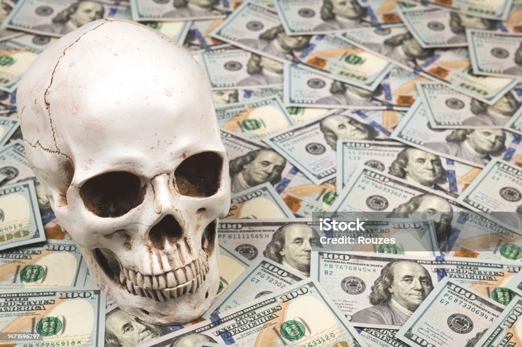Skull on pile of 100 dollar bills skull and money American One Hundred Dollar Bill Stock Photo