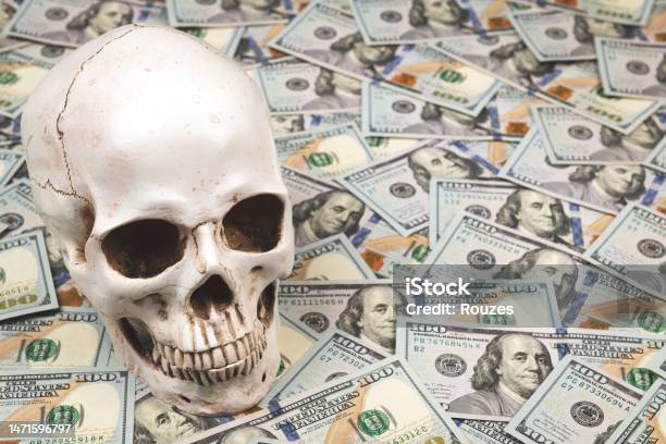 Skull On Pile Of 100 Dollar Bills Stock Photo - Download Image Now - American One Hundred Dollar Bill, Austerity, Bank - Financial Building