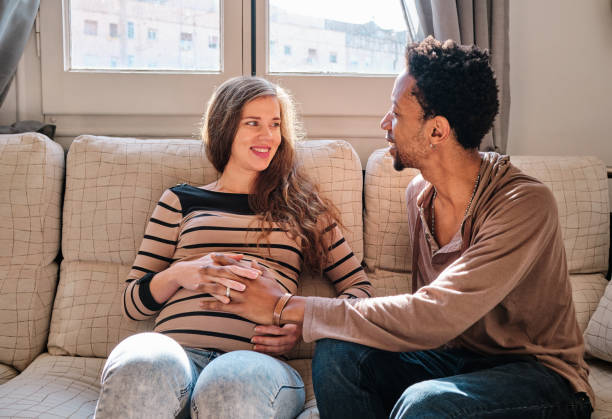 istock Happy multiethnic couple smiling while expecting a baby. 1471597705