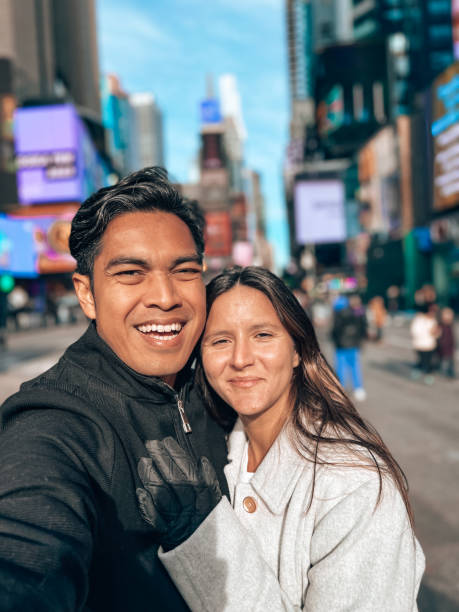 istock Couple taking selfie at time square 1471598446