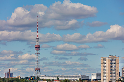 Kyiv TV tower in a summer cityscape against a cloudy sky, Kyiv, Ukraine. Copy space.