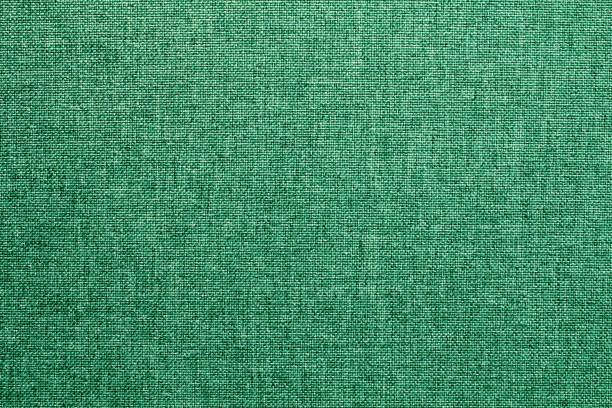 istock Abstract design background of emerald green coarse-grained intersection texture of rough fabric with an interlacing 1471600313