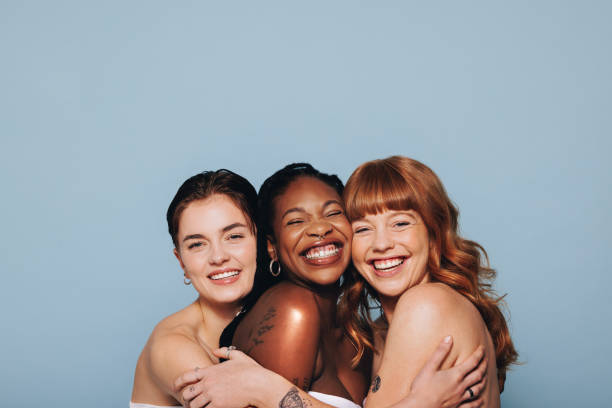 istock Three women with different skin tones embracing each other 1471601424