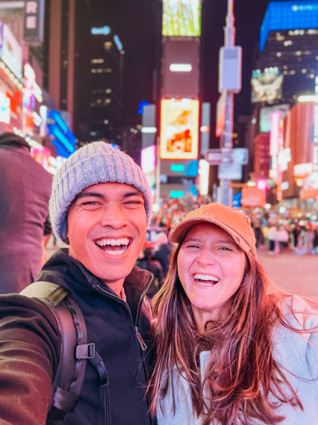 istock Couple taking selfie at time square 1471601446