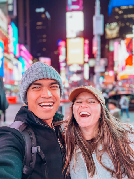 istock Couple taking selfie at time square 1471601559