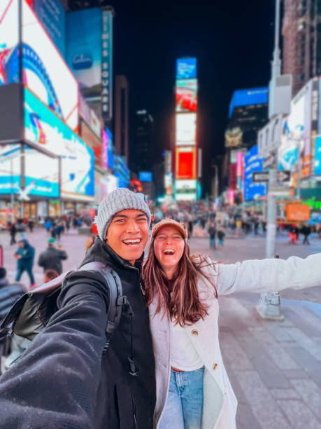 istock Couple taking selfie at time square 1471601560