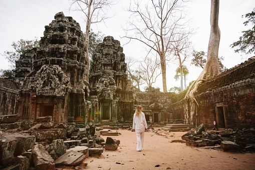 Traveler Exploring Ancient Ruins of Ta Prohm Temple at Angkor
