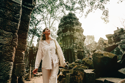 Traveler Exploring Ancient Ruins of Ta Prohm Temple at Angkor