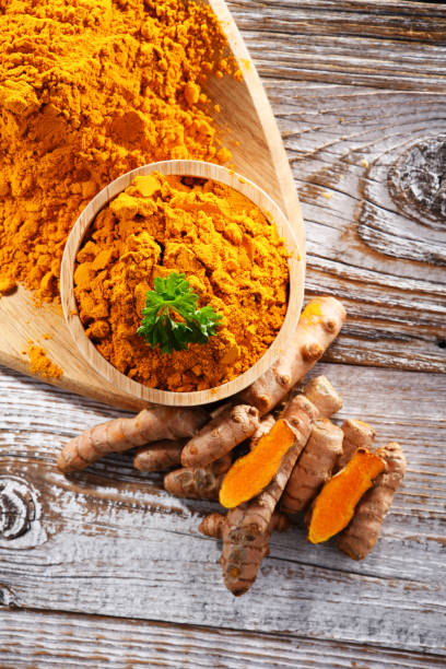 istock Composition with a bowl of ground turmeric and its fresh rhizome 1471604687