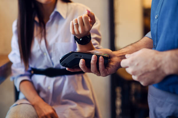 istock Woman pay by smart watch with NFC technology. 1471605250