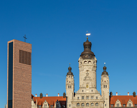Top of the main entrance of the Leipzig City hall with the St. Trinity Catholic Church looking to it