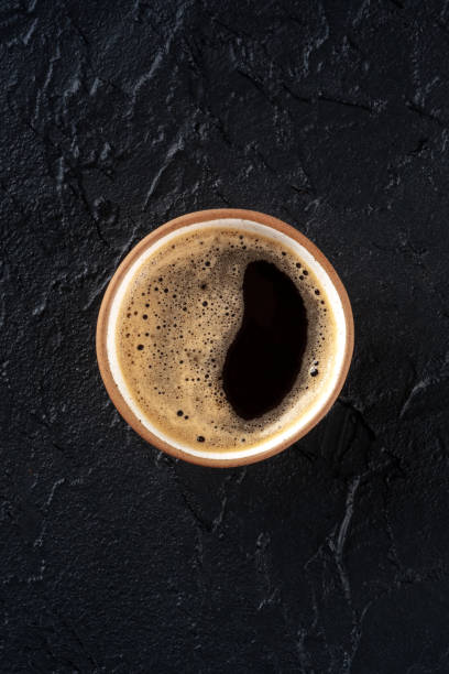 istock Coffee cup, top shot on a black stone background with copy space 1471608970