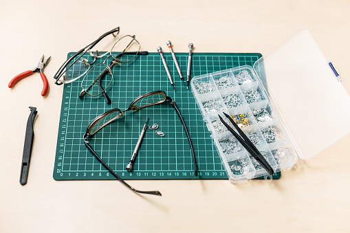 kit for repairing used eyeglasses on wooden table