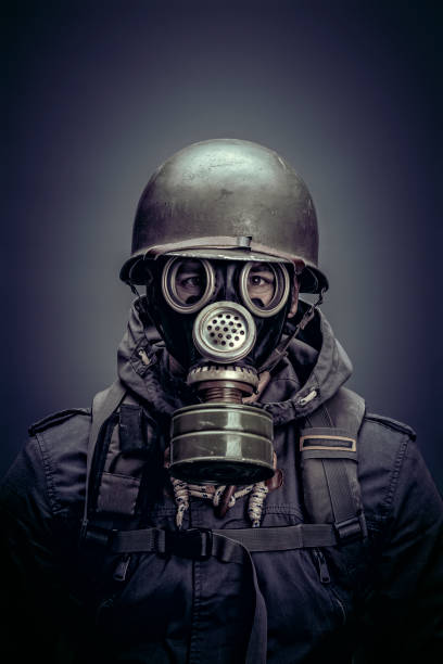 istock soldier with helmet and gas mask 1471609599