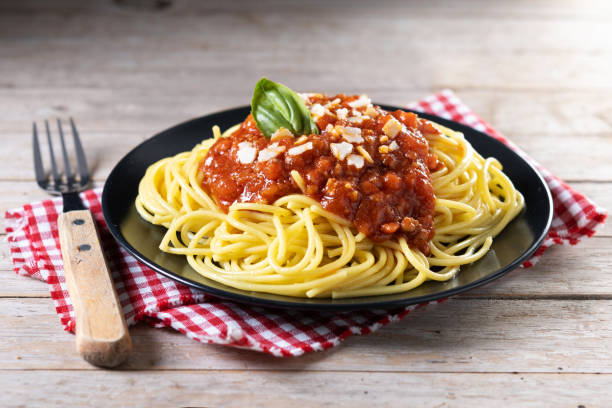 Spaghetti with bolognese sauce on wooden table