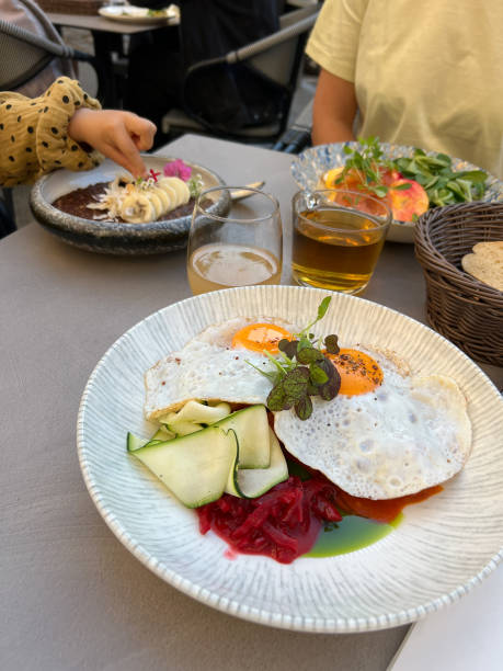 istock Fried eggs with greens on a plate on the table 1471614570