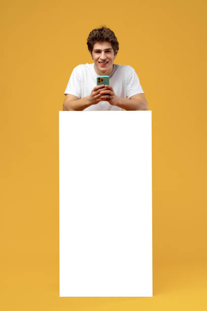 istock Cheerful guy demonstrate empty space blank offer on yellow background 1471616033