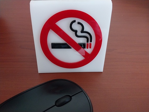 Discover a clear and readable vinyl no smoking sign in a hotel room. This photo showcases the sign that enforces a smoke-free policy for the comfort and health of guests. Use this photo as a reference to ensure compliance with the rules and maintain a healthy smoke-free environment.