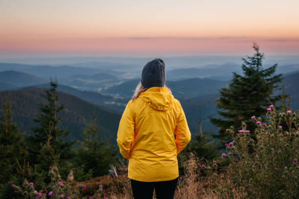 istock Hiker enjoying view at sunset over mountain range 1471621451