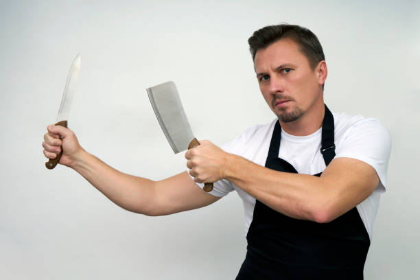 istock Young man with holding cutting knives 1471621534