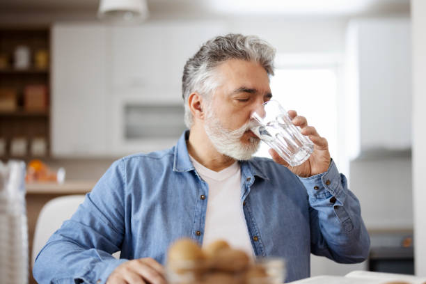 istock Man Drinking Glass of Water 1471622054