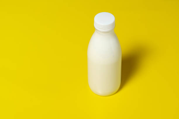 istock Bottle of milk isolated on yellow background 1471623357