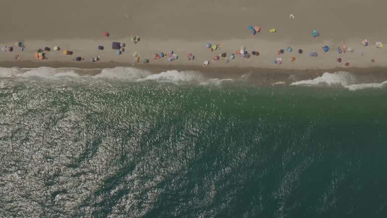 Aerial view of people on the beach in summertime, Sicily, Italy.