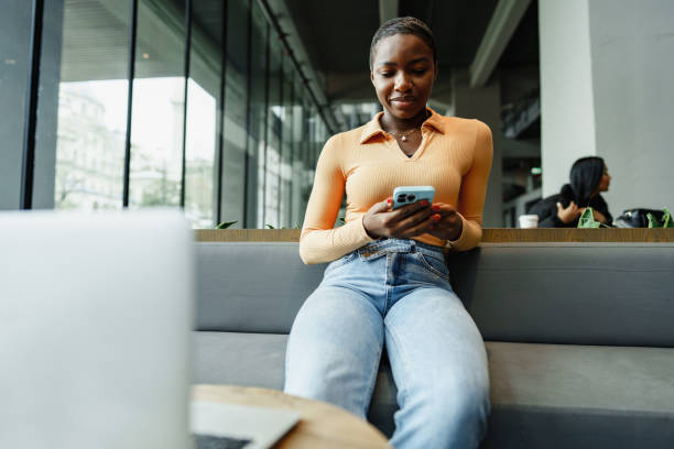 istock African female student working on computer in public place 1471624244