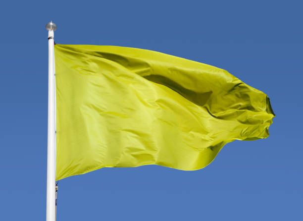 istock yellow flag with sky background 1471626315