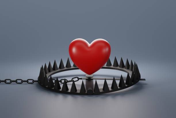 istock Heart over a snare, a trap on a dark background. 1471628923