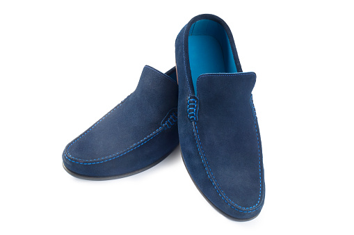 Studio shot of mens blue suede casual shoes cut out against a white background
