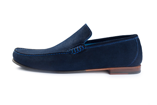 Studio shot of mens blue suede casual shoes cut out against a white background