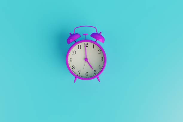istock Violet retro alarm clock on turquoise background. 1471631940
