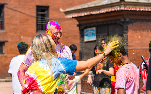 Group of tourist's exchange greetings of joy and happiness with celebrating color festival Holi at Kathmandu, Nepal, on  Monday March 06, 2023