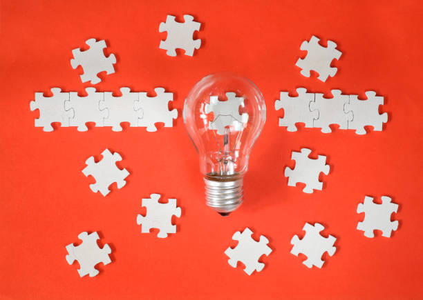 istock Business concept,recruitment,human resources,innovation, team building.Light bulb and jigsaw puzzle with one piece missing. Free copy space. 1471637437