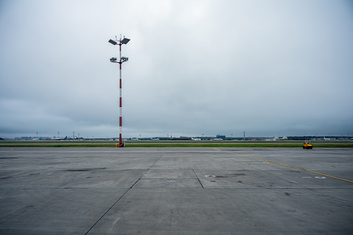 Moody sky over the airfield. Empty airport runway