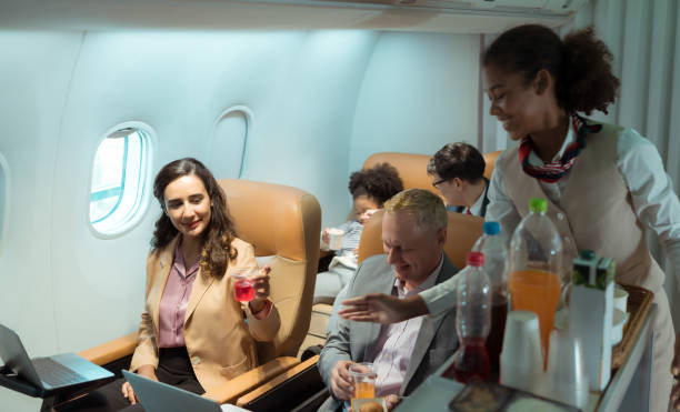 istock Flight attendant serving food and drinks to passengers 1471639559