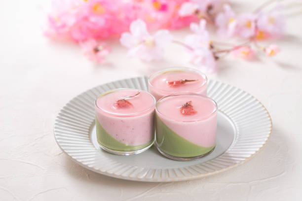 Mousse with two flavors, matcha and strawberry with cherry blossoms flavored jelly stock photo