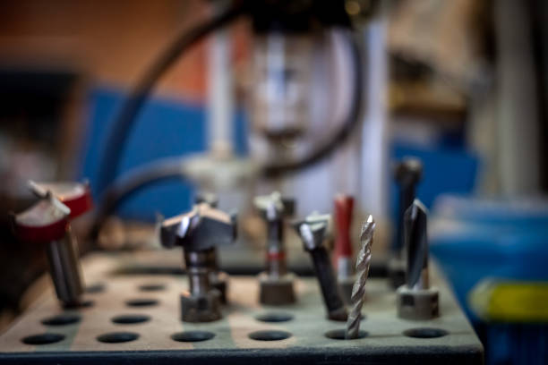 Picture of pieces of drills on display in a carpenter workshop, professional grade, designed for drilling wood, in a carpenter industrial workshop. Drill bits are cutting tools used to remove material to create holes, almost always of circular cross-section. Drill bits come in many sizes and shapes and can create different kinds of holes in many different materials