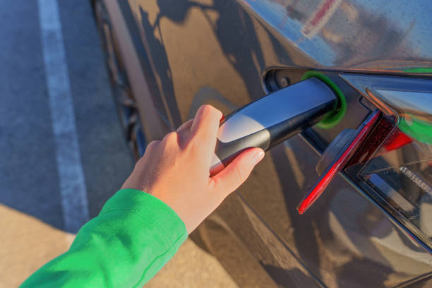 istock Human Hand Attaching Electric Vehicle Charging Connector 1471641840