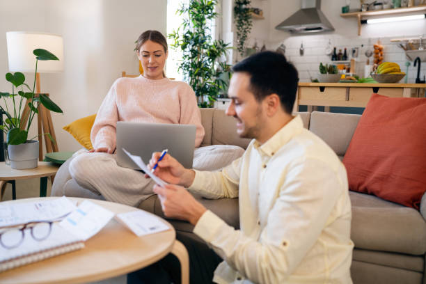 istock Pregnant couple organizing home finances 1471644507