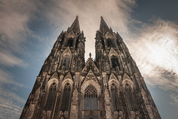 cologne cathedral seen from below with blue sky. cologne cathedral, or kolner dom, is the main landmark of cologne and a catholic church in germany. - catedral de colónia imagens e fotografias de stock